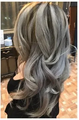 After: layered silver-gray balayage, styled in loose waves